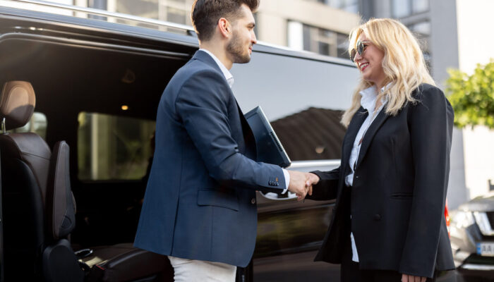 female-chauffeur-with-a-businessman-near-minivan-t-2025-03-13-15-32-27-utc
