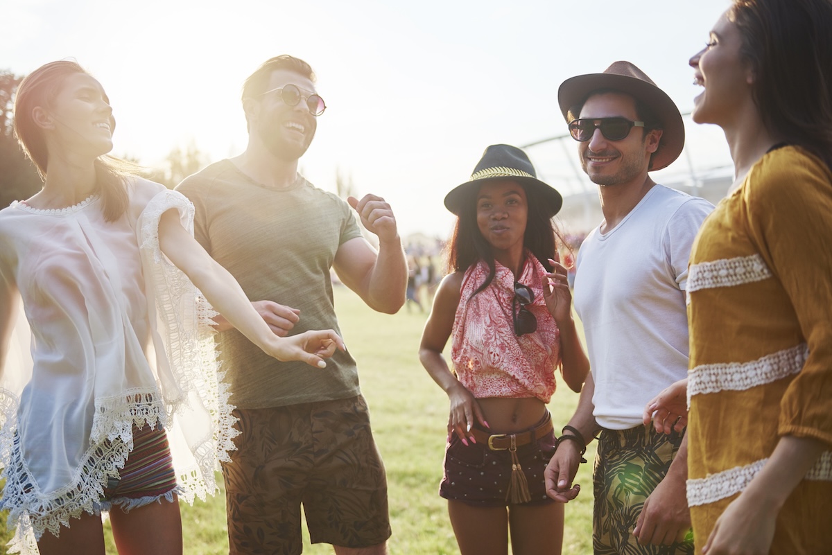 Five young adult friends dancing and having fun at Holi Festival