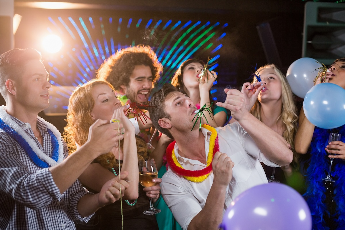 group-of-smiling-friends-blowing-party-horn-in-bar-2026-01-11-10-30-52-utc