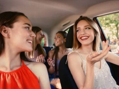 Happy beautiful young women together in car